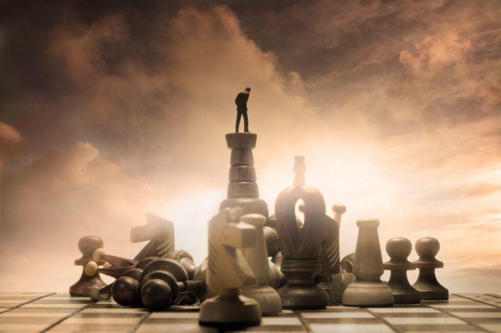 developing-resourcefulness-man-atop-chess-set