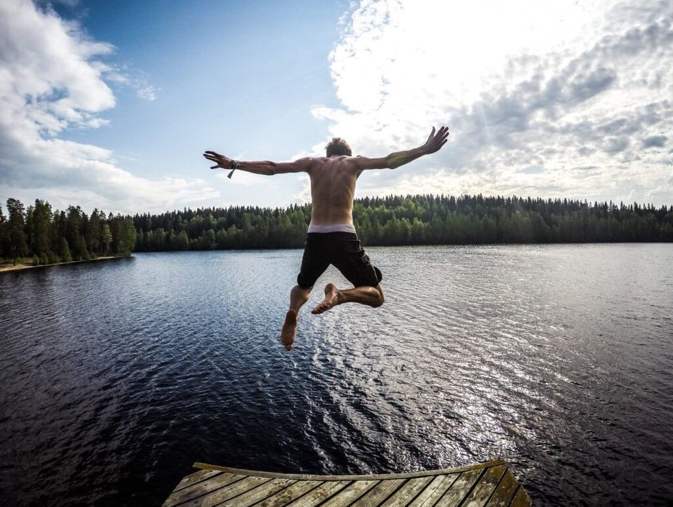 man-jumping-lake