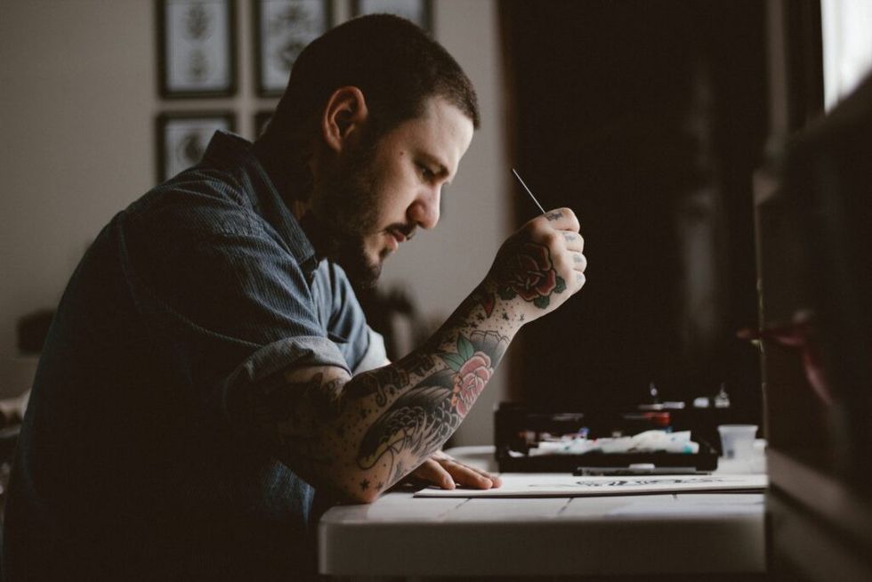 Tattooed-man-working-at-a-desk