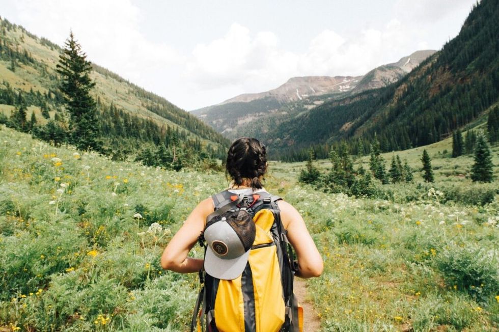 Woman-backpacking-through-wilderness