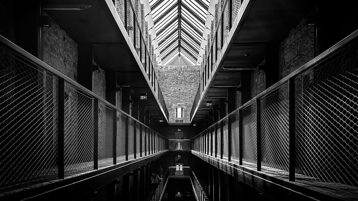 a black and white photo of a long hallway