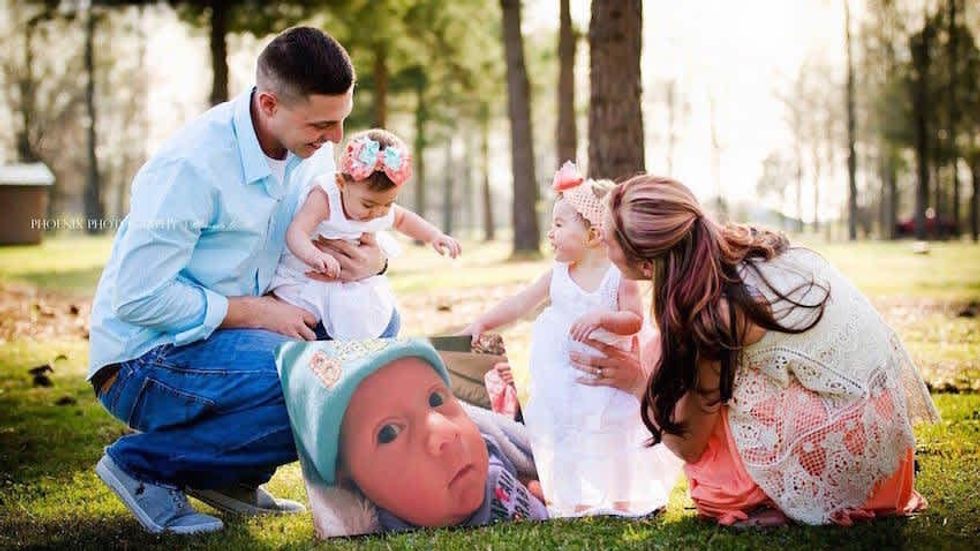 a couple holding two children in a field