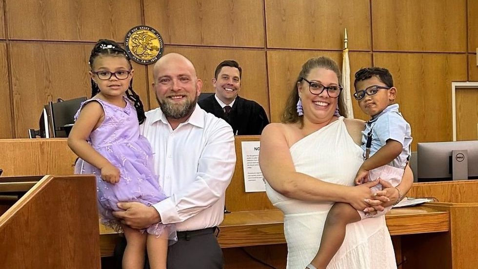 a judge and a man and a woman carrying two children