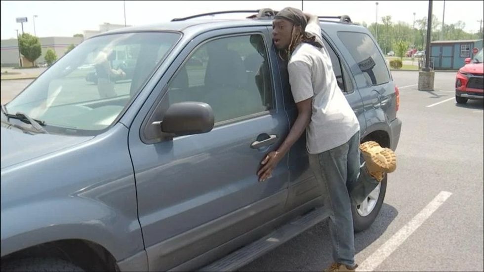 a man hugging a car