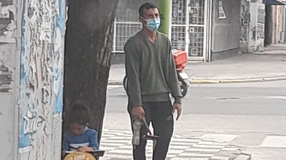 a man standing while his daughter does homework