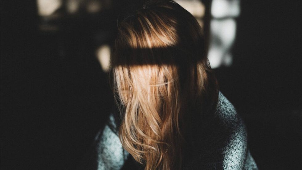 A sad woman in the shadows