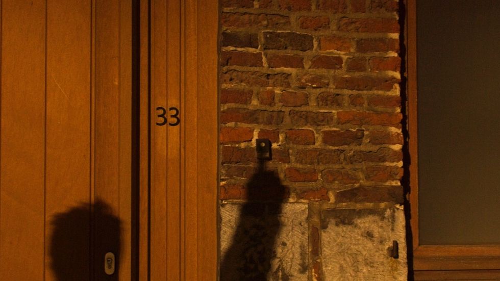 a shadow of a person on a brick wall