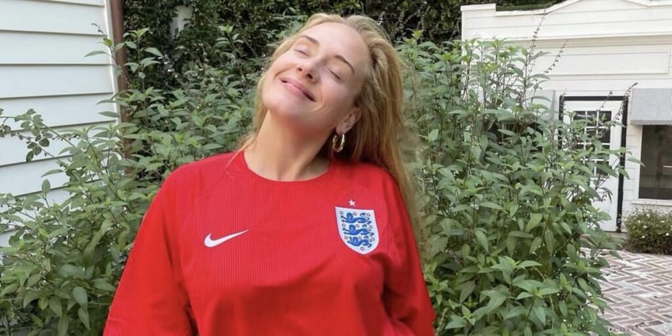 Adele in red sports jersey smiling