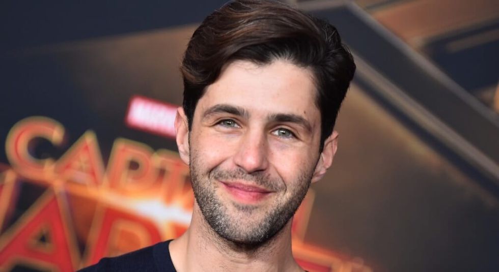 Adult Josh Peck smiling at the camera in black shirt.