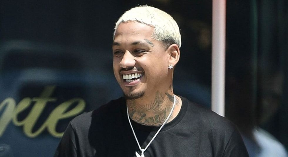 Alexander Edwards smiling wearing a black t-shirt.