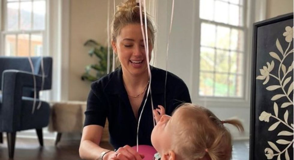 Amber Heard playing with her young daughter.