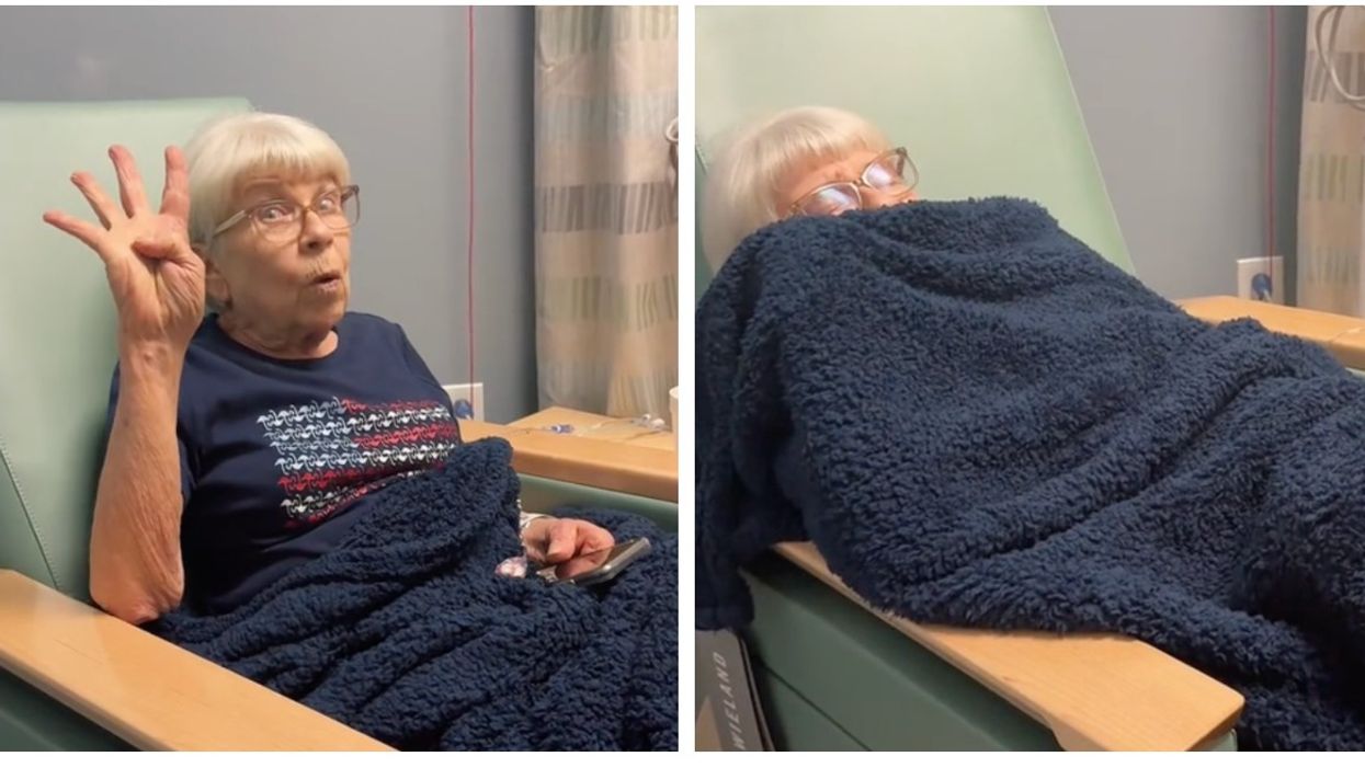 An elderly woman sits in chair with blue blanket while doing chemotherapy.