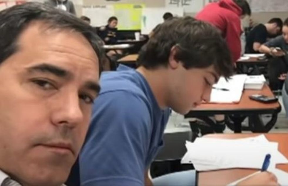 an older man next to a teen in class at school