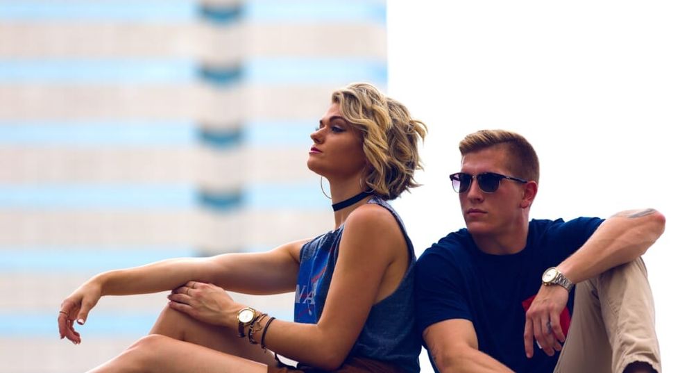 backs to each other young couple