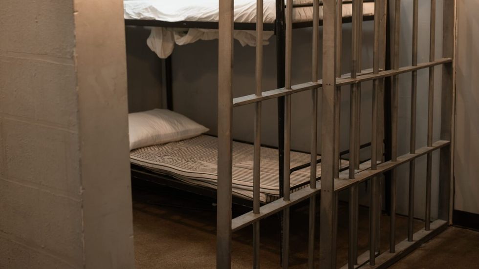 bed in a prison cell
