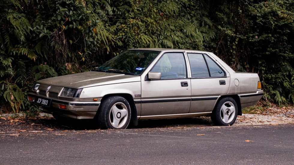 beige car parked on the side of the road
