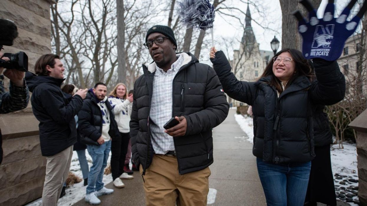 Benard McKinley walking through the Arch of Northwestern University
