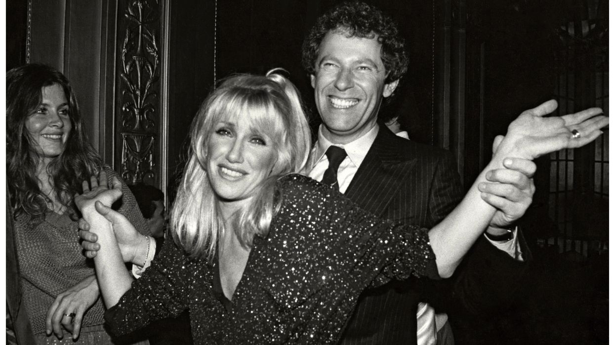 Black and white photo of Suzanne Somers and husband Alan Hamel dancing and posing for the camera while at Studio 54.