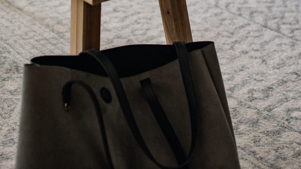 black bag leaning against a table