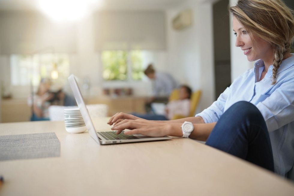 blonde-woman-smiling-working-laptop