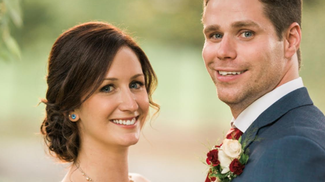 Bride and groom smile during wedding photo shoot.