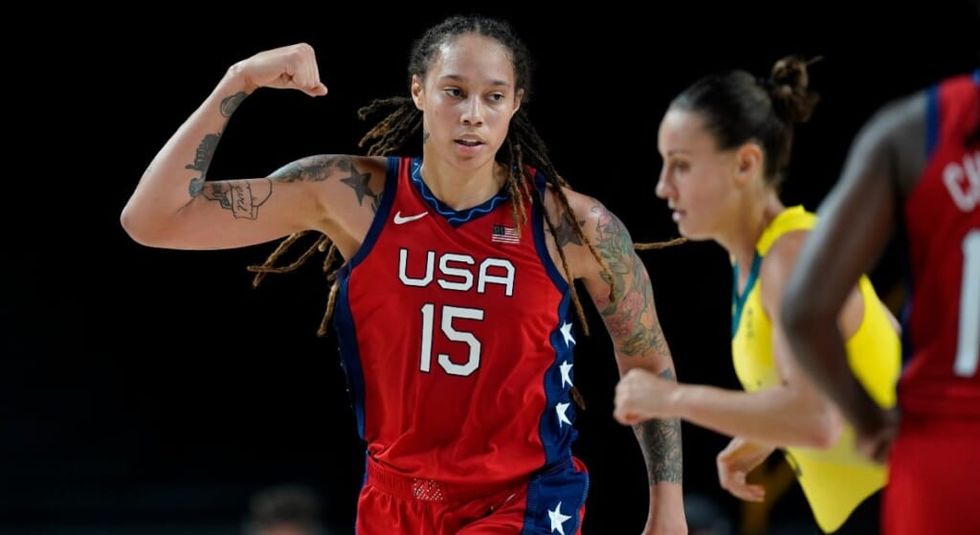 Brittney Griner in her #15 USA Jersey with her fist pumped up.
