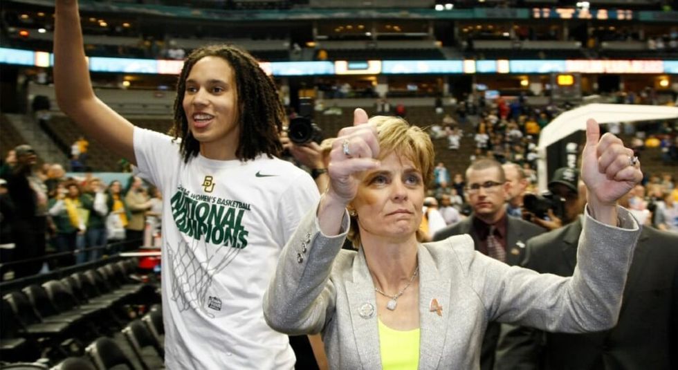 Brittney Griner with coach Kim Mulkey both cheering to the crowd.