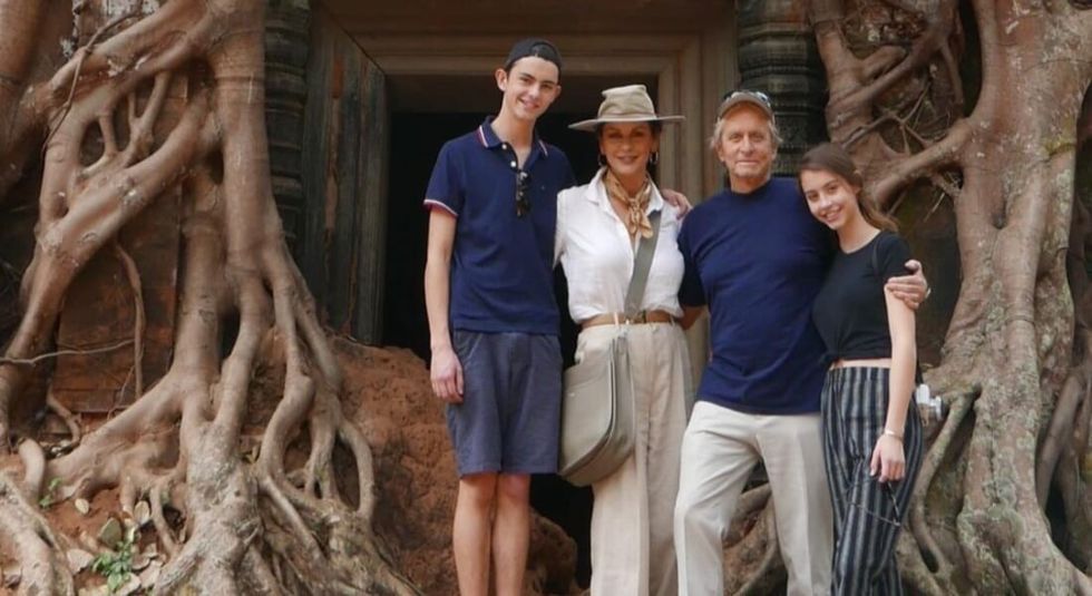 Catherine Zeta-Jones and Michael Douglas posing with children. </p><p>