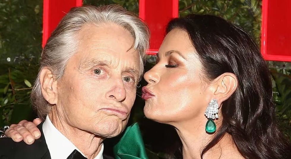 Catherine Zeta-Jones kissing husband Michael Douglas on the cheek.