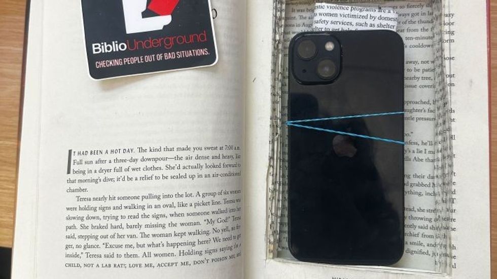 cell phone hidden inside a book