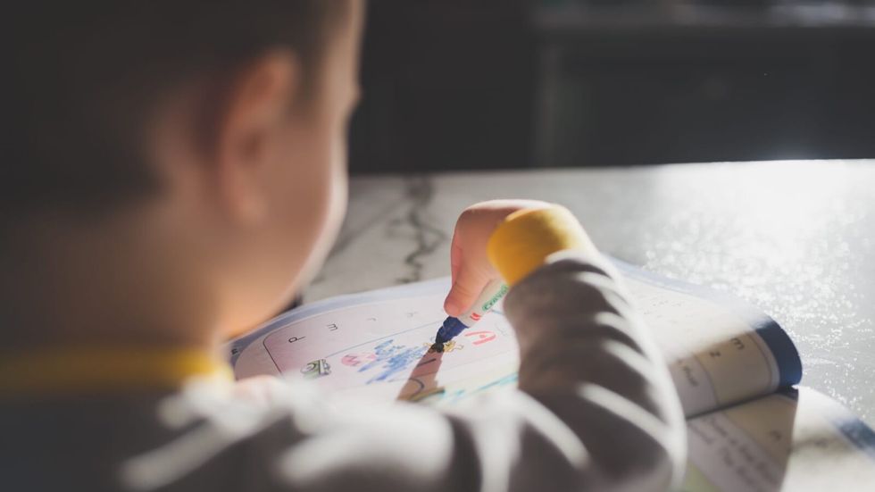 child coloring in a book