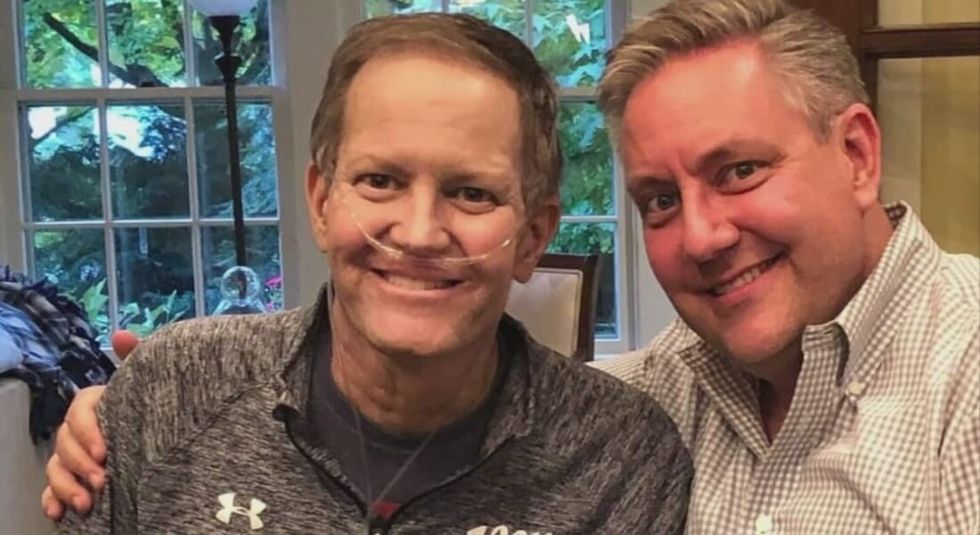 Chris Bradley posing with husband.