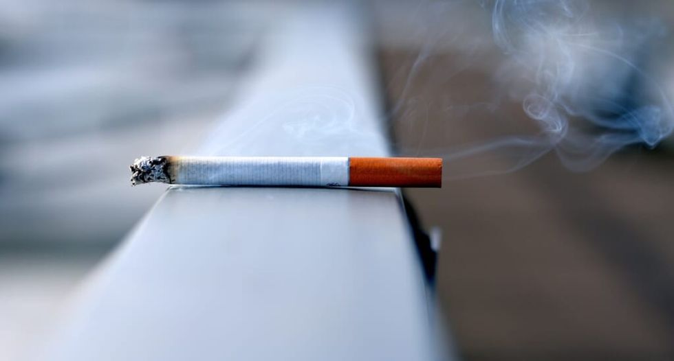 cigarette is lit smoke plumes