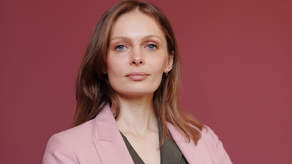 confident woman in pink suit