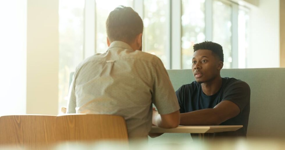 counseling between two men in the daytime sunny room