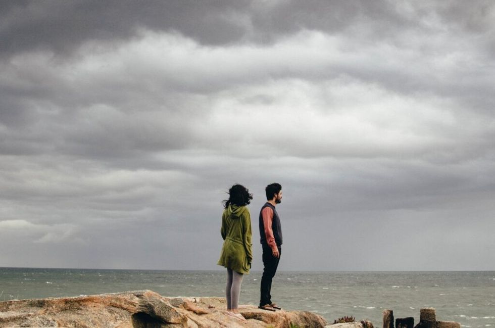 Couple-standing-on-a-cliff