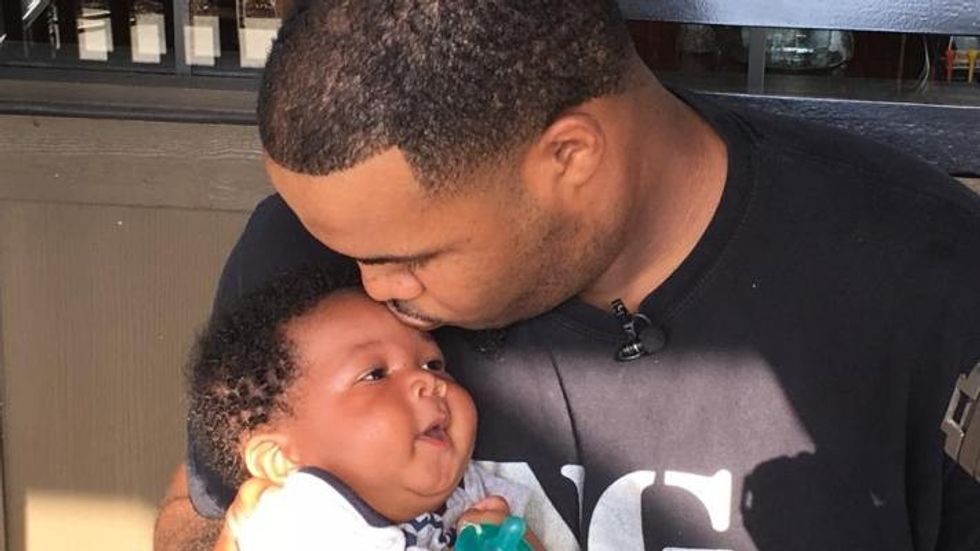 dad kissing his little son