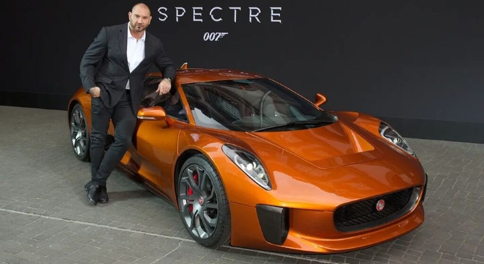 Dave Batista posing with the Spectre Jaguar.