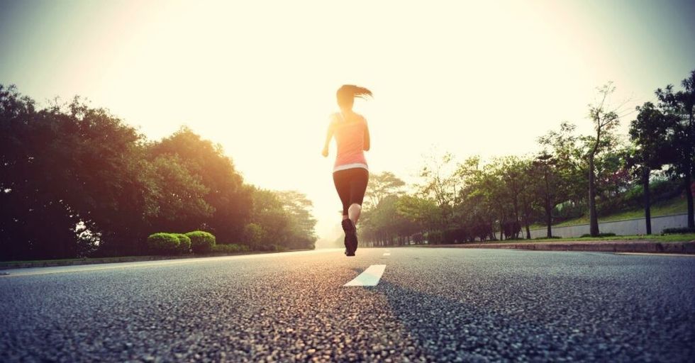 discipline woman athlete running jogging at dawn sunset on the road path