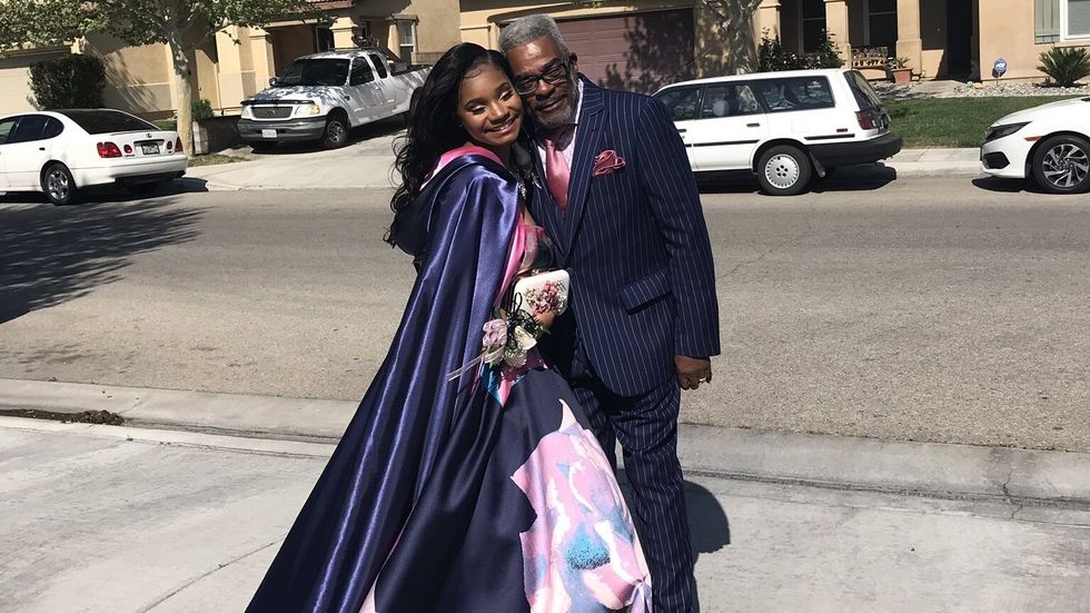 elderly man taking a picture with his granddaughter