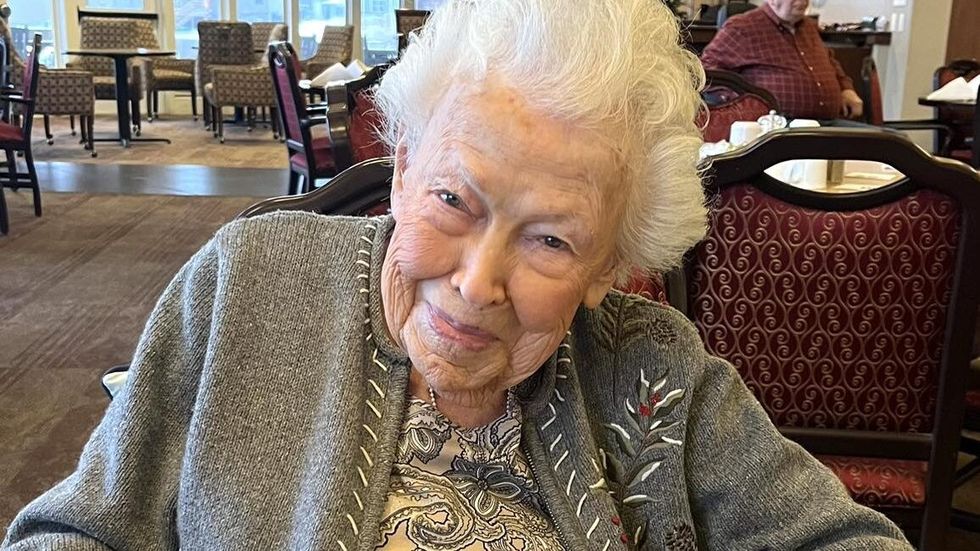 elderly woman wearing a grey sweater