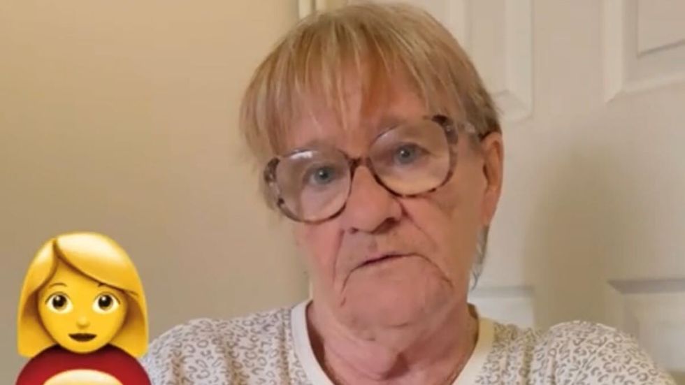 elderly woman with short blonde hair and glasses