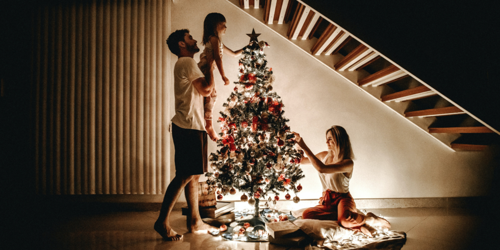 family decorating Christmas tree