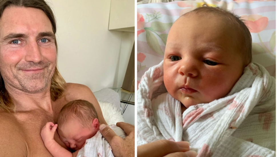 father cuddling newborn daughter