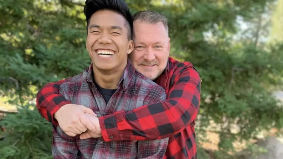 father hugging his son