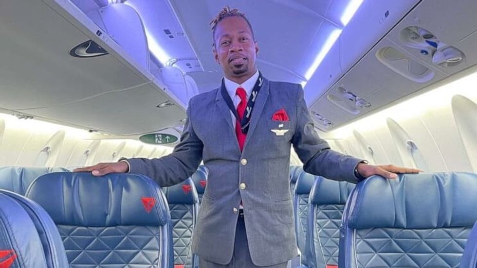 flight attendant standing in a plane aisle