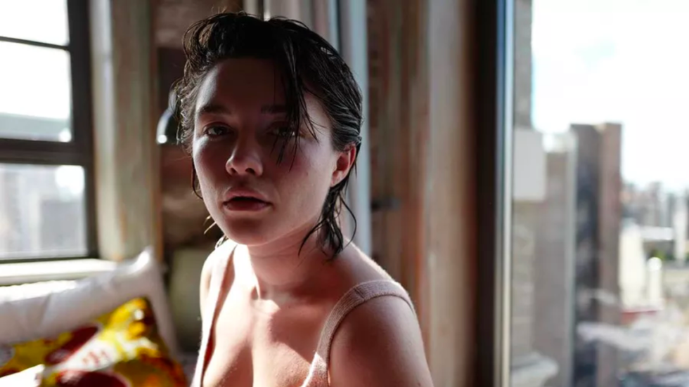 Florence Pugh with damp short brown hair.