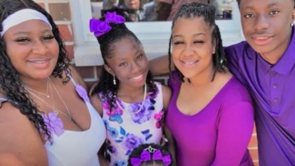 four people wearing purple