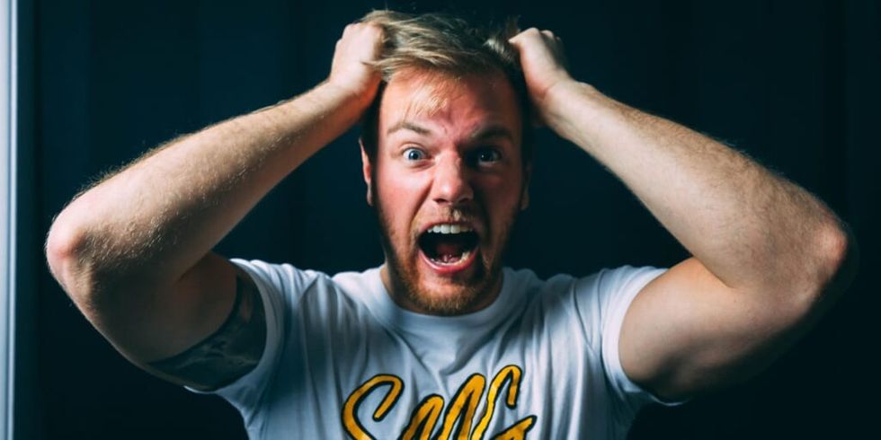 Frustrated man pulling hair by Ryan Snaadt by Unsplash