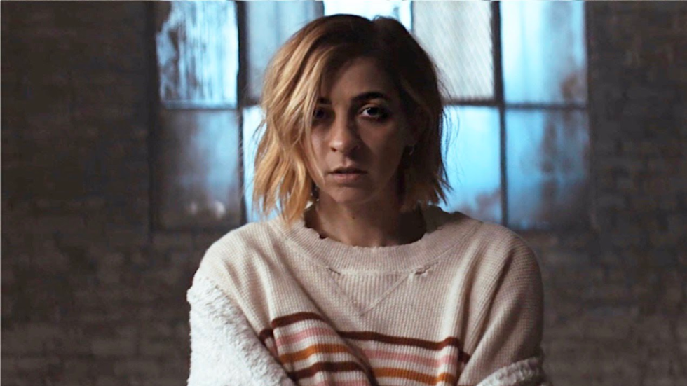 Gabbie Hanna staring at the camera, looking haggard.